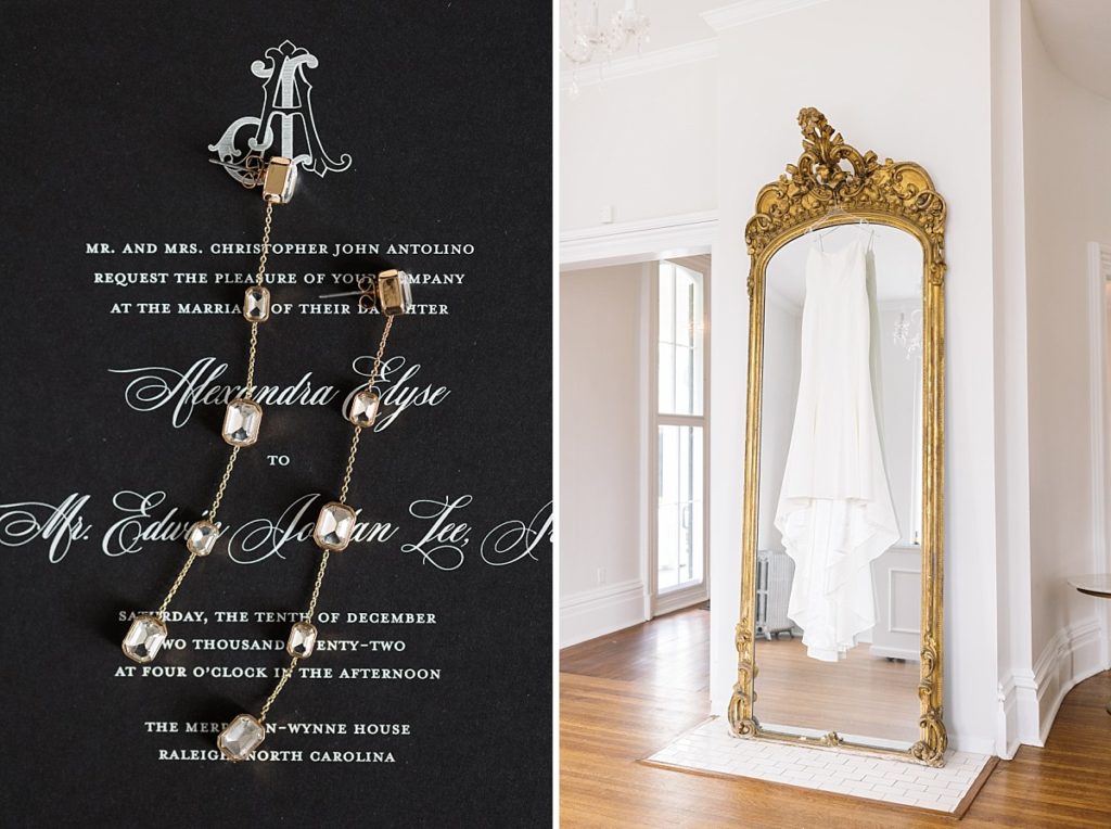 Gold and diamond earrings on black invitation and wedding dress hanging from Gold antique mirror | Classic Black and white wedding at Merrimon-Wynne | Raleigh NC Wedding Photographer 