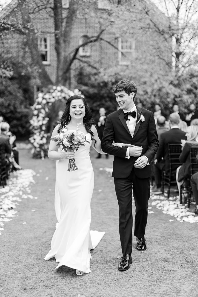 Bride and groom walking down the aisle as husband and wife | Classic Black and white wedding at Merrimon-Wynne | Raleigh NC Wedding Photographer 