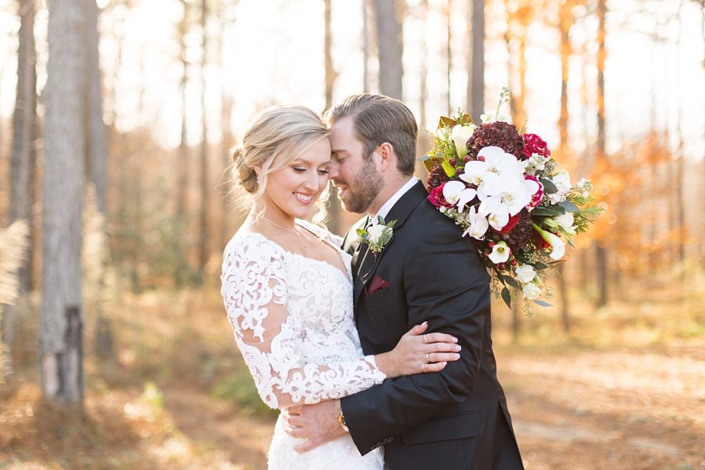 Christmas bride and groom embracing  | Christmas Wedding at Pinehill Pavilion | Raleigh NC Wedding Photographer 