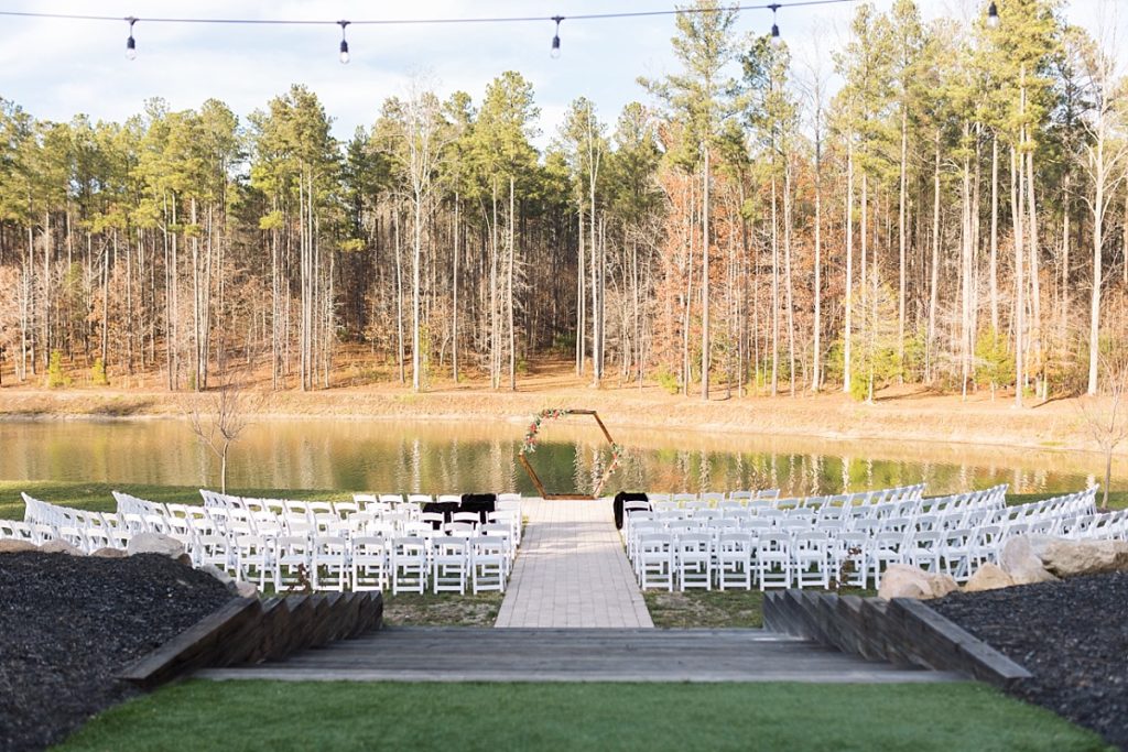 Hexagon wedding arch with lake as backdrop | Christmas Wedding at Pinehill Pavilion | Raleigh NC Wedding Photographer 
