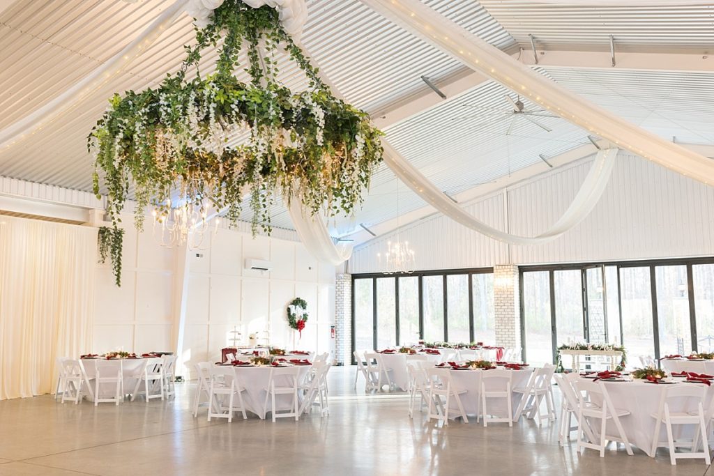 Chandelier covered in greenery and florals | Christmas Wedding at Pinehill Pavilion | Raleigh NC Wedding Photographer 