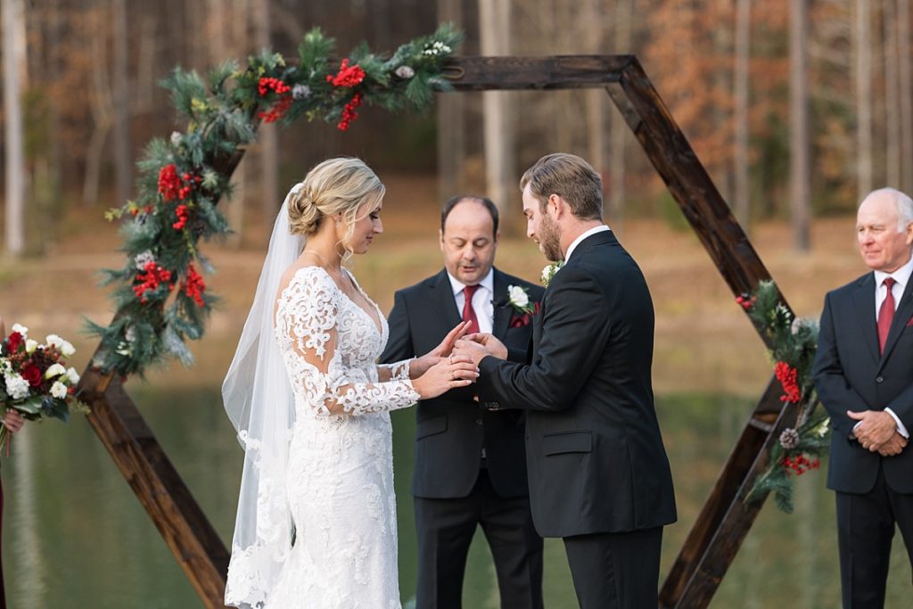 Bride and groom exchanging rings | Christmas Wedding at Pinehill Pavilion | Raleigh NC Wedding Photographer 