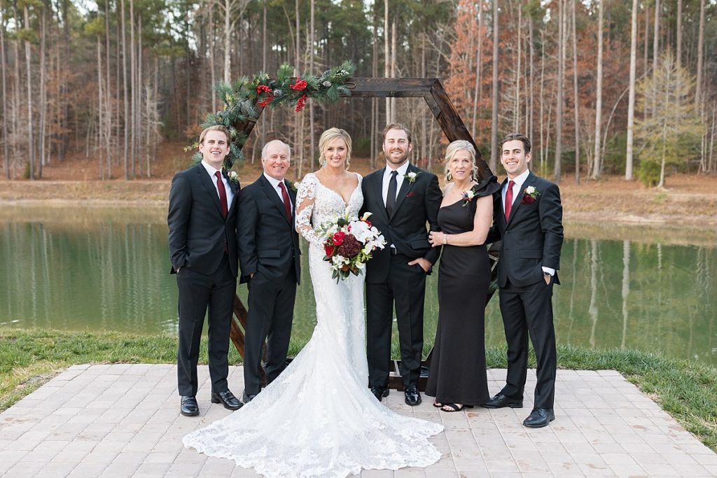 Bride and groom with grooms family | Christmas Wedding at Pinehill Pavilion | Raleigh NC Wedding Photographer 
