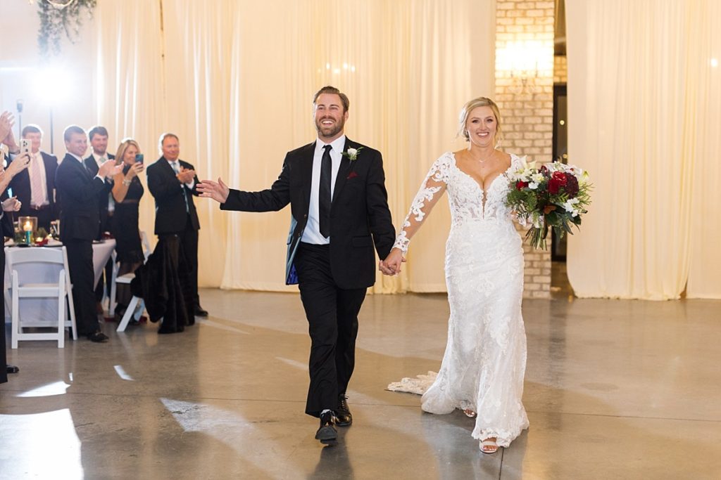 Bride and groom entering reception | Christmas Wedding at Pinehill Pavilion | Raleigh NC Wedding Photographer 