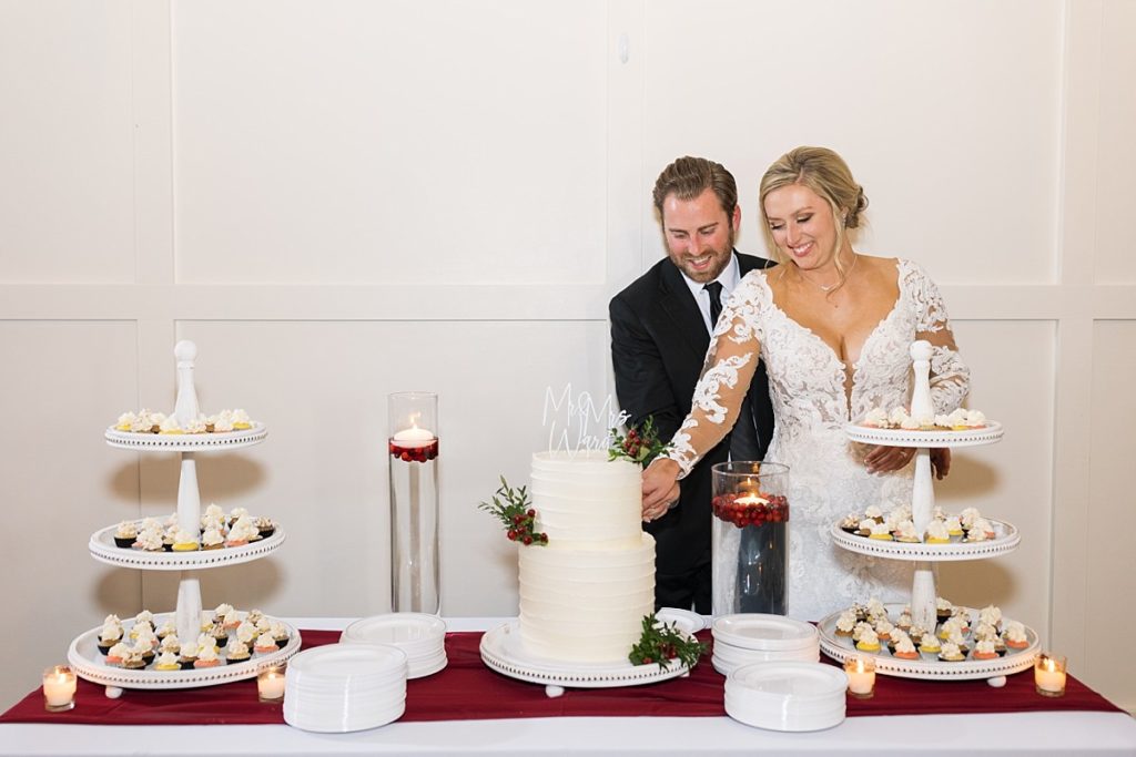 Christmas bride and groom cutting their cake | Christmas Wedding at Pinehill Pavilion | Raleigh NC Wedding Photographer 