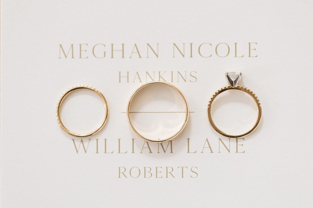 gold wedding bands laying on White and gold wedding invite Emerald Christmas Wedding at The Sutherland Estate | Raleigh NC Wedding Photographer