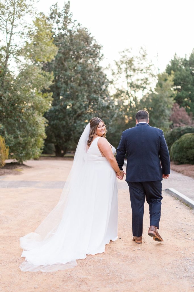 Bride and groom walking | Emerald Christmas Wedding at The Sutherland Estate | Raleigh NC Wedding Photographer