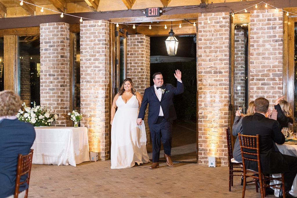Bride and groom entering their reception | Emerald Christmas Wedding at The Sutherland Estate | Raleigh NC Wedding Photographer