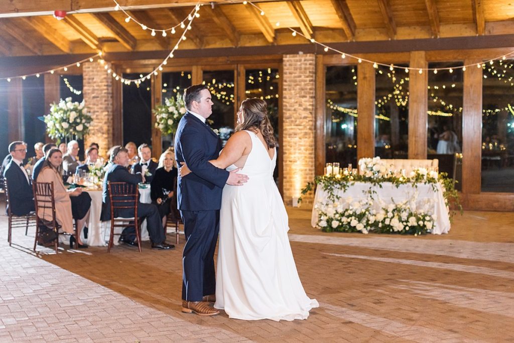 bride and groom sharing their first dance | Emerald Christmas Wedding at The Sutherland Estate | Raleigh NC Wedding Photographer