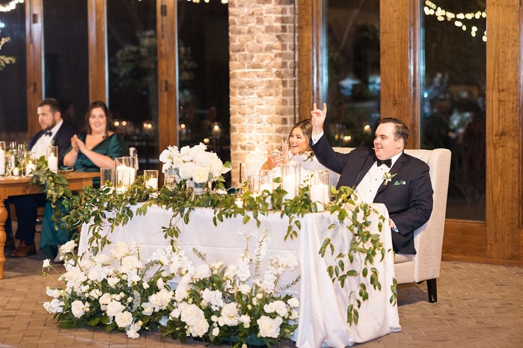 Bride and groom at their sweetheart table | Emerald Christmas Wedding at The Sutherland Estate | Raleigh NC Wedding Photographer
