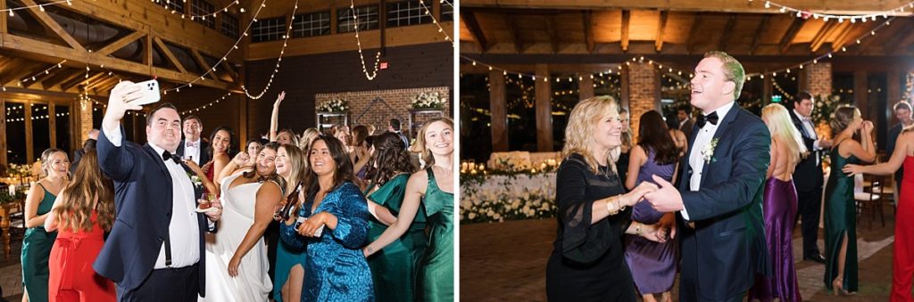 Bride and groom taking a selfie with their guests on the dance floor | Emerald Christmas Wedding at The Sutherland Estate | Raleigh NC Wedding Photographer