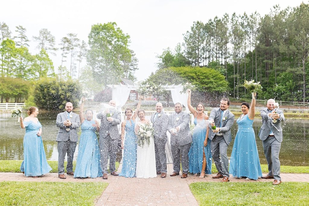 wedding party popping champagne | Raleigh NC wedding photographer 