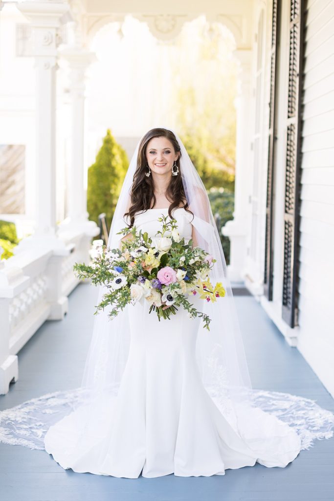 Bride holding bouquet outside on porch | Bridal Portraits at Merrimon-Wynne | Raleigh NC Wedding Photographer | Bridal Portrait Photographer