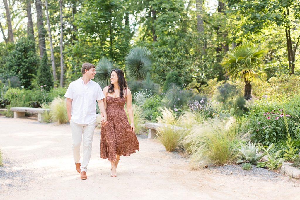 couple walking in garden | Duke Gardens engagement photos | Raleigh NC wedding photographer 