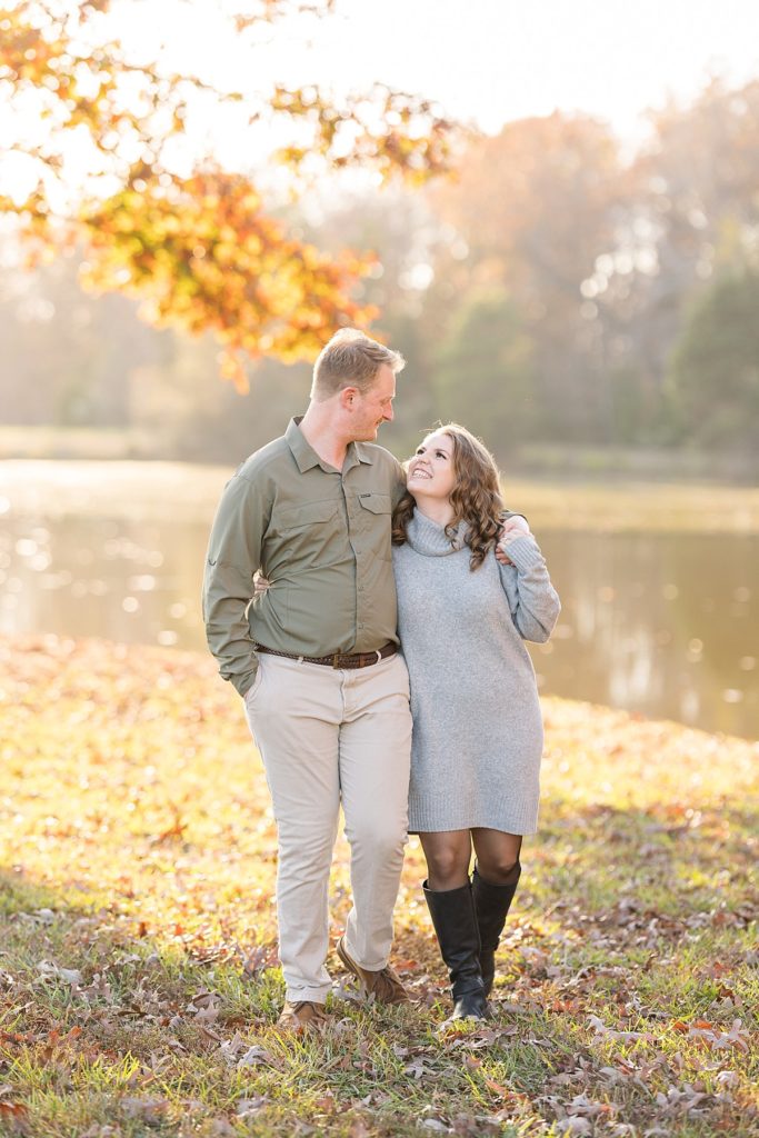 Couple smiling at each other during engagement photo shoot | Fall Engagement at The Farmstead | Raleigh NC Wedding & Engagement Photographer 