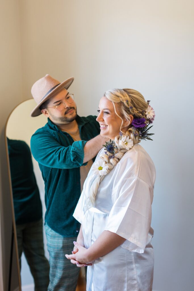 Bride having her hair styled with flowers | Tangled Inspired Spring Wedding at Walnut Hill | Raleigh NC Wedding Photographer
