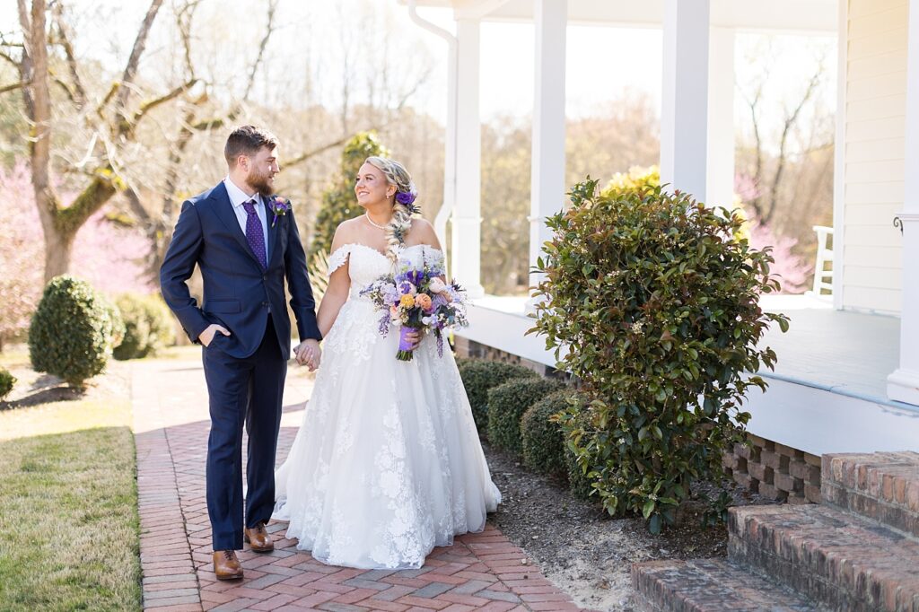 Bride and groom walking hand in hand  | Raleigh NC Wedding Photographer