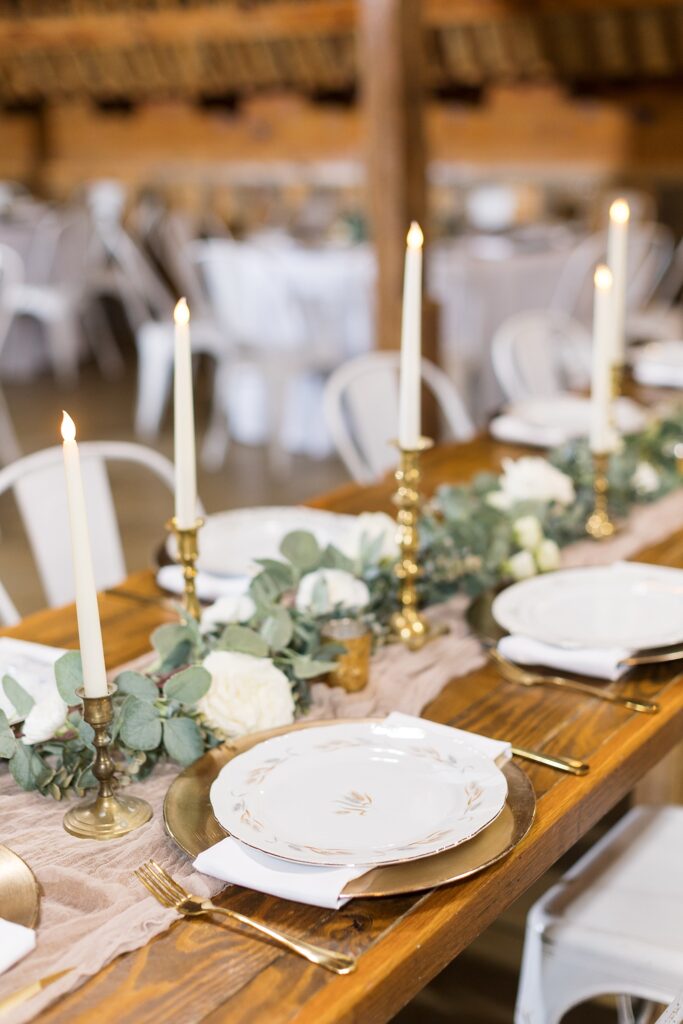 Wedding table décor showing candlesticks and plates | Amazing Graze Barn Wedding | Amazing Graze Barn Wedding Photographer