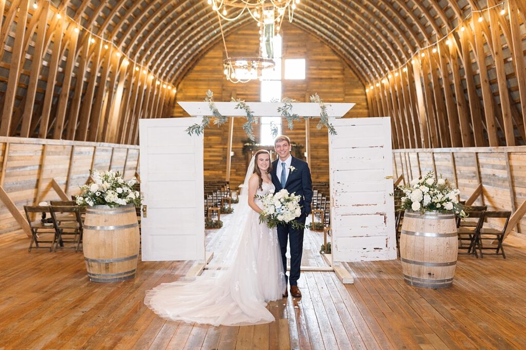 Bride and groom in barn with bridal bouquet | Amazing Graze Barn Wedding | Amazing Graze Barn Wedding Photographer