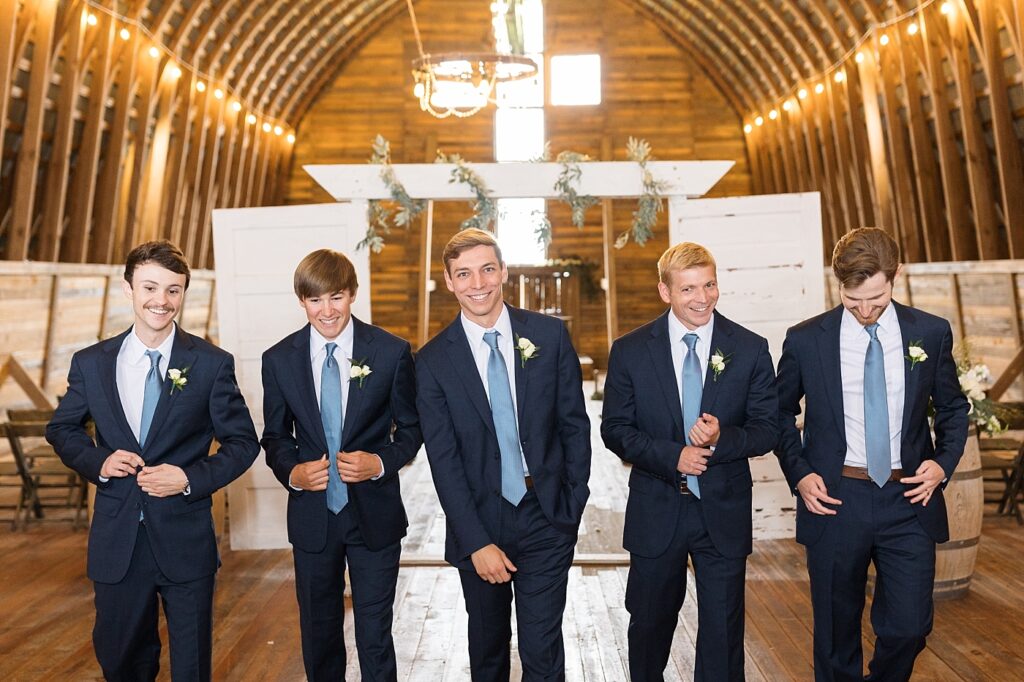 Groom and groomsmen walking in barn | Amazing Graze Barn Wedding | Amazing Graze Barn Wedding Photographer