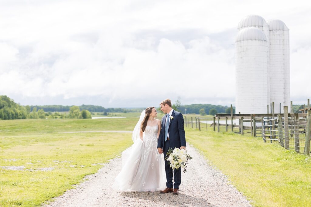 Bride and groom looking at each other outside barn | Amazing Graze Barn Wedding | Amazing Graze Barn Wedding Photographer