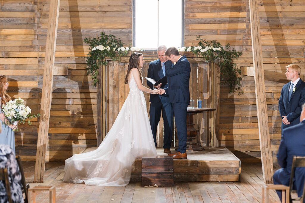 Wedding ceremony and groom wiping tears | Amazing Graze Barn Wedding | Amazing Graze Barn Wedding Photographer
