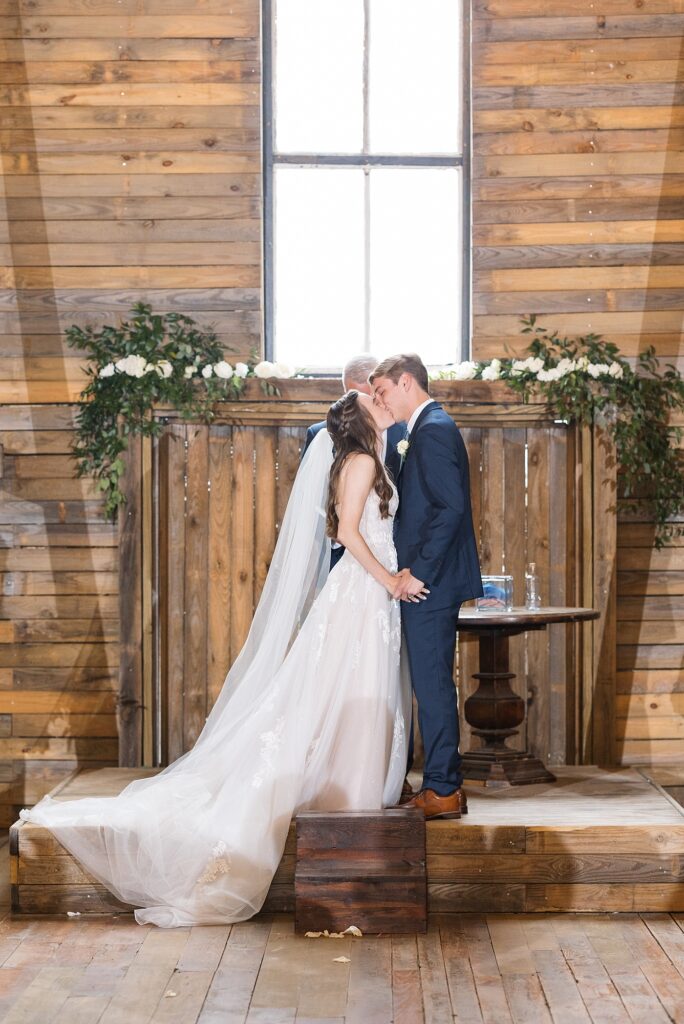 Bride and groom holding kissing after ceremony | Amazing Graze Barn Wedding | Amazing Graze Barn Wedding Photographer