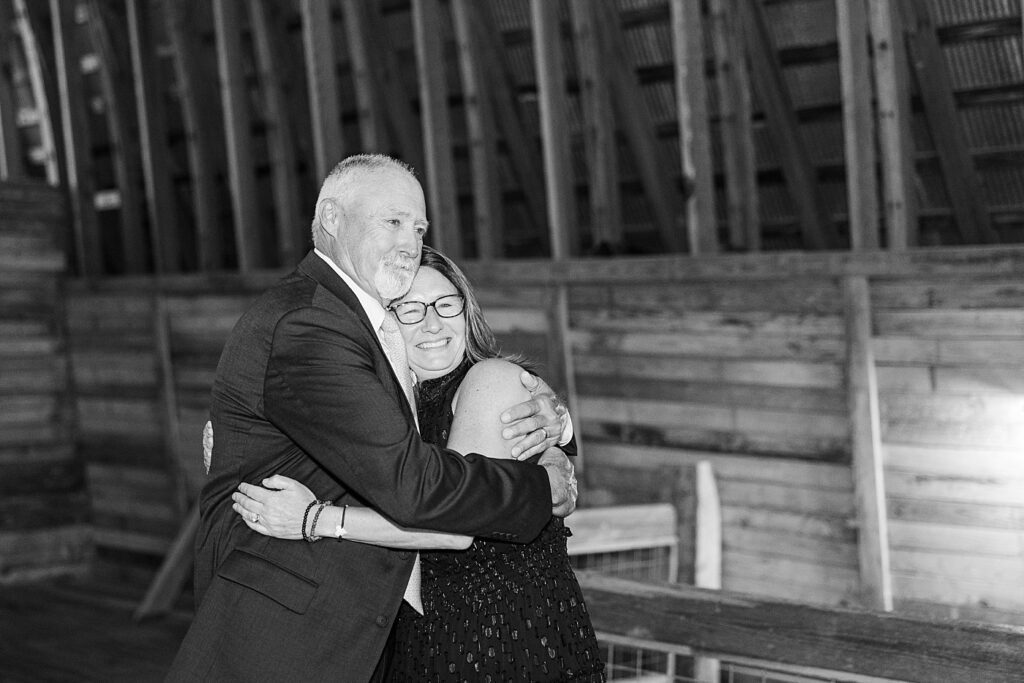 Bride's parents hugging after ceremony | Amazing Graze Barn Wedding | Amazing Graze Barn Wedding Photographer