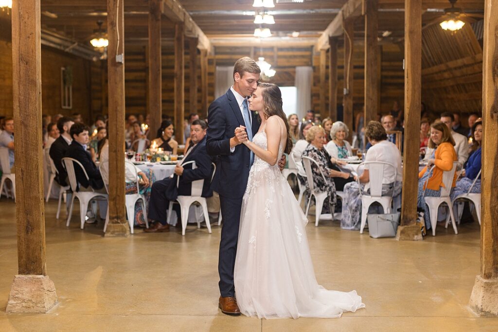 Bride and groom holding hands during first dance | Amazing Graze Barn Wedding | Amazing Graze Barn Wedding Photographer