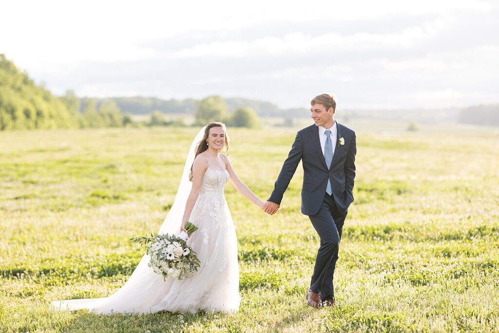 Bride and groom holding hands outside barn | Amazing Graze Barn Wedding | Amazing Graze Barn Wedding Photographer