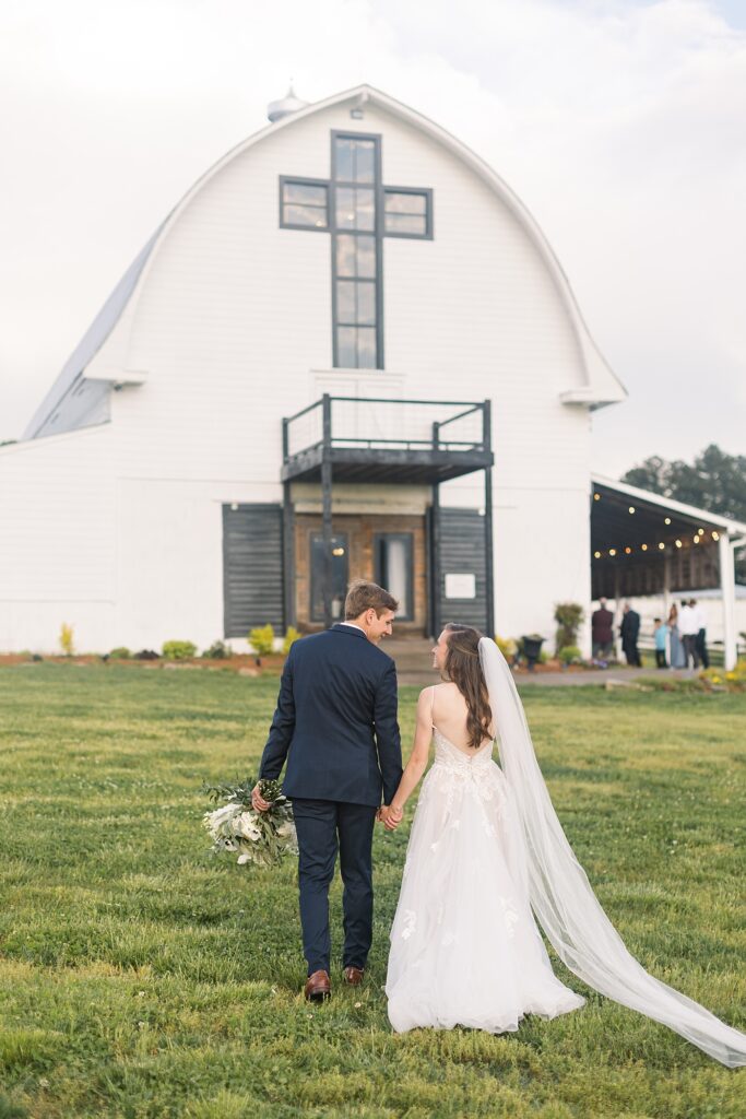 Bride and groom in front of barn entrance  | Amazing Graze Barn Wedding | Amazing Graze Barn Wedding Photographer
