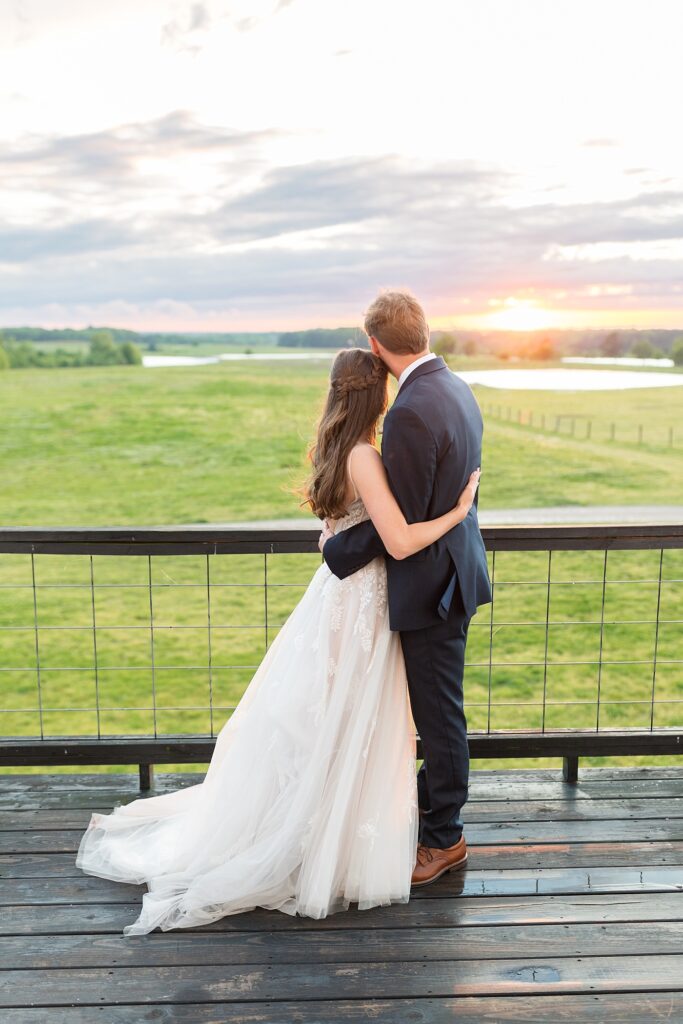 Bride and groom watching the sunset outside barn | Amazing Graze Barn Wedding | Amazing Graze Barn Wedding Photographer
