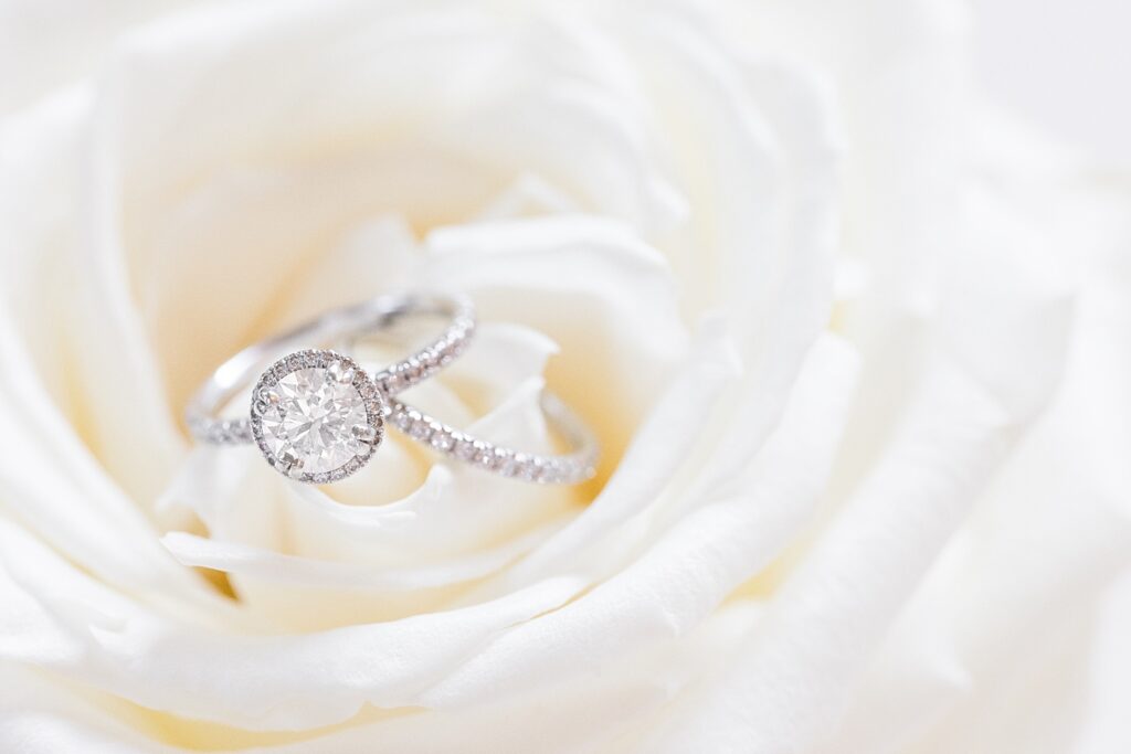 Engagement ring and wedding band sitting on white flower | The Bradford Wedding | The Bradford Wedding Photographer 