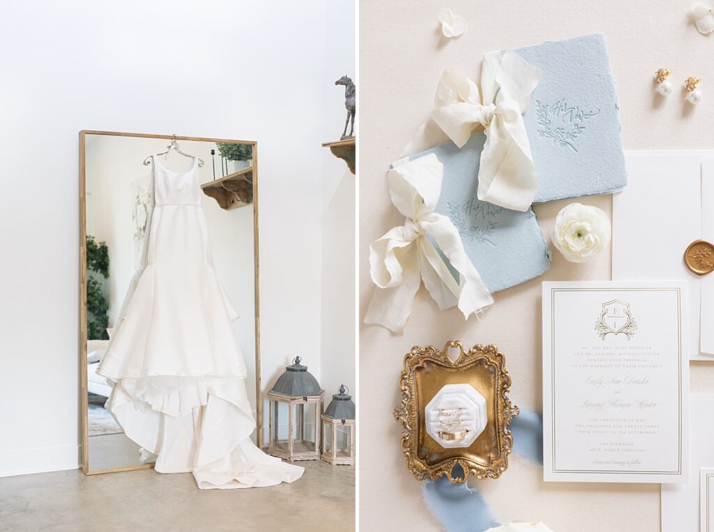 Wedding rings and invitations displayed with blue and white colors and bride's dress hanging from mirror | The Evermore Wedding | The Evermore Wedding Photographer | Raleigh NC Wedding Photographer