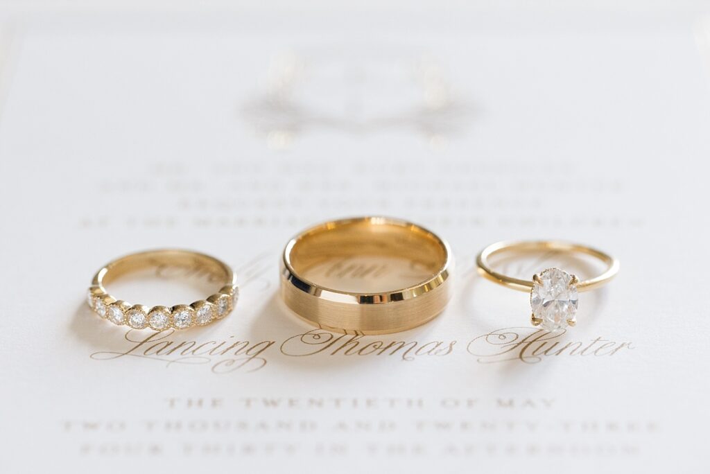 Wedding rings displayed on top of wedding invitation | The Evermore Wedding | The Evermore Wedding Photographer | Raleigh NC Wedding Photographer