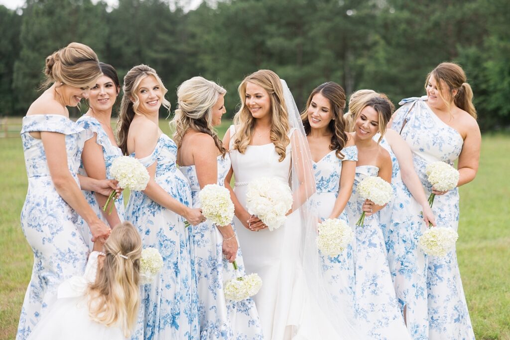 Bride and bridesmaids smiling and holding peony bouquet | The Evermore Wedding | The Evermore Wedding Photographer | Raleigh NC Wedding Photographer