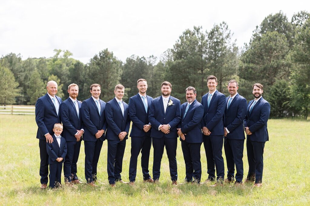 Groom posing with groomsmen | The Evermore Wedding | The Evermore Wedding Photographer | Raleigh NC Wedding Photographer