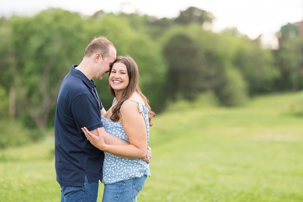 Couple embracing in open field | Raleigh NC Engagement Photographer | Sarah Hinckley Wedding Photographer