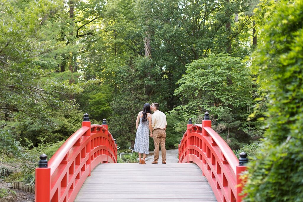 Couple holding hands on bridge | Duke Gardens engagement photos | Raleigh NC wedding photographer 