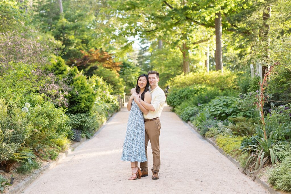 Couple embracing in garden | Duke Gardens engagement photos | Raleigh NC wedding photographer 