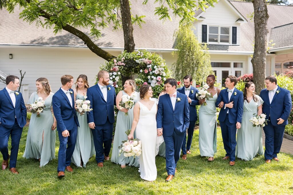 Bride and groom walking with wedding party | Spring Wedding | The Matthews House Wedding | The Matthews House Wedding Photographer | Raleigh NC Wedding Photographer