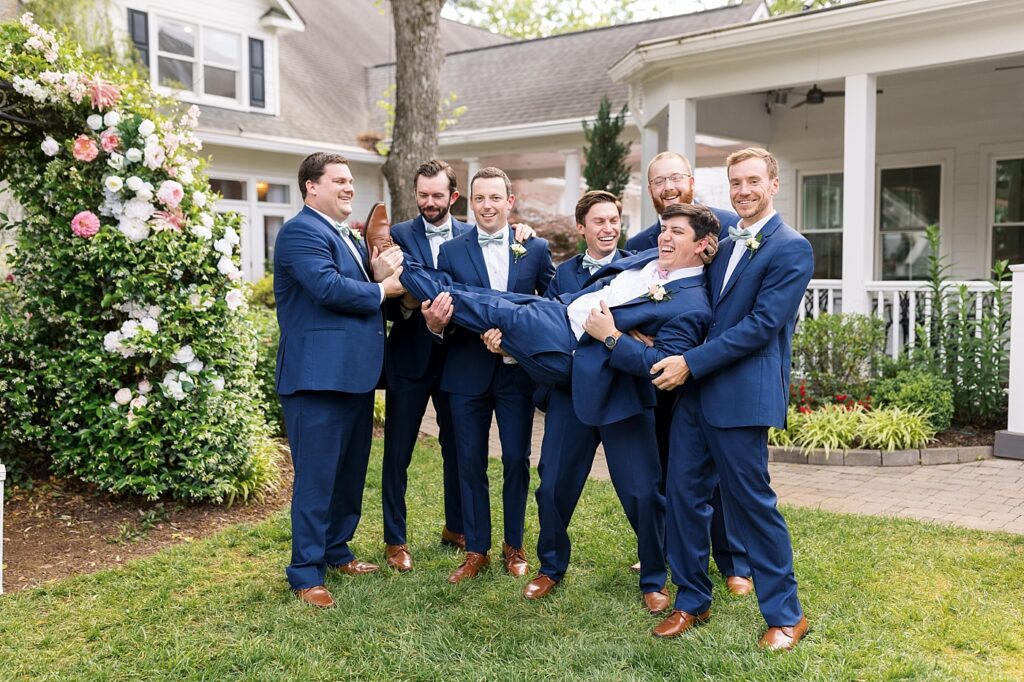 Groomsmen carrying groom | Spring Wedding | The Matthews House Wedding | The Matthews House Wedding Photographer | Raleigh NC Wedding Photographer