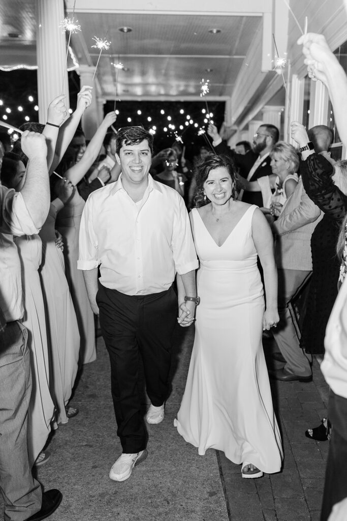 Bride and groom holding hands during sparkler exit | Spring Wedding | The Matthews House Wedding | The Matthews House Wedding Photographer | Raleigh NC Wedding Photographer