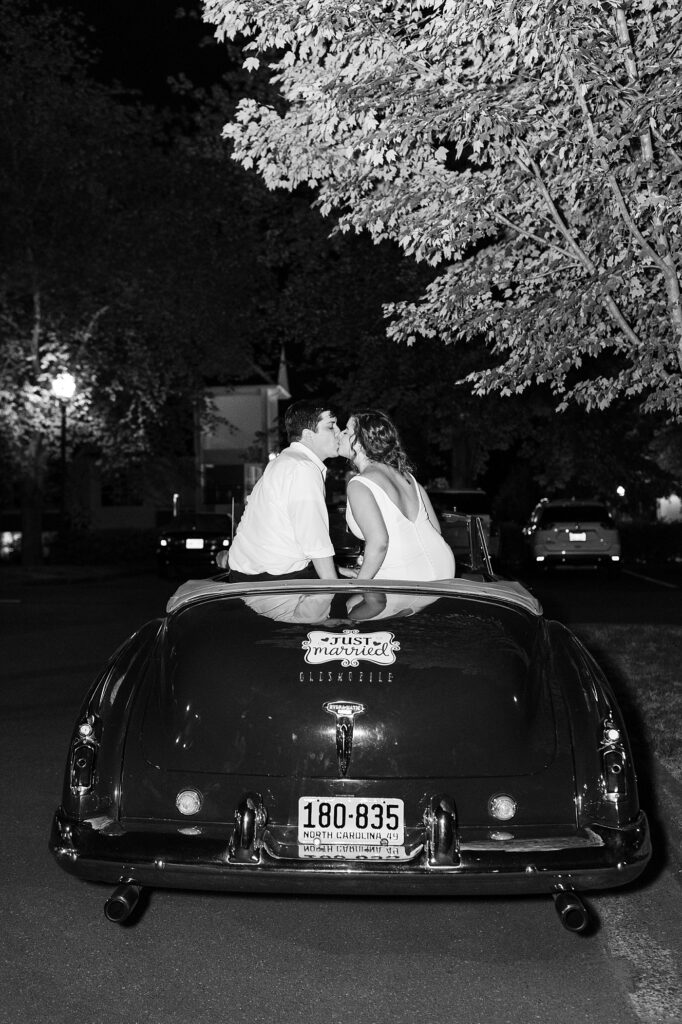 Bride and groom kissing while sitting on "just married" car | Spring Wedding | The Matthews House Wedding | The Matthews House Wedding Photographer | Raleigh NC Wedding Photographer