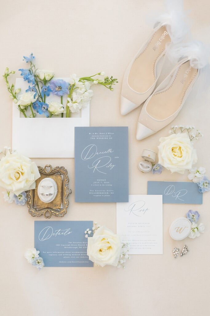 Blue and white wedding invitations and flowers with bridal shoes and wedding rings | Blue and white Wedding | Carolina Groves Wedding | Carolina Groves Wedding Photographer | Raleigh NC Wedding Photographer