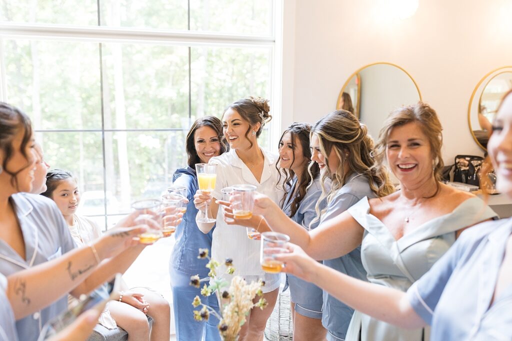 Bride toasting with bridesmaids | Blue and white Wedding | Carolina Groves Wedding | Carolina Groves Wedding Photographer | Raleigh NC Wedding Photographer