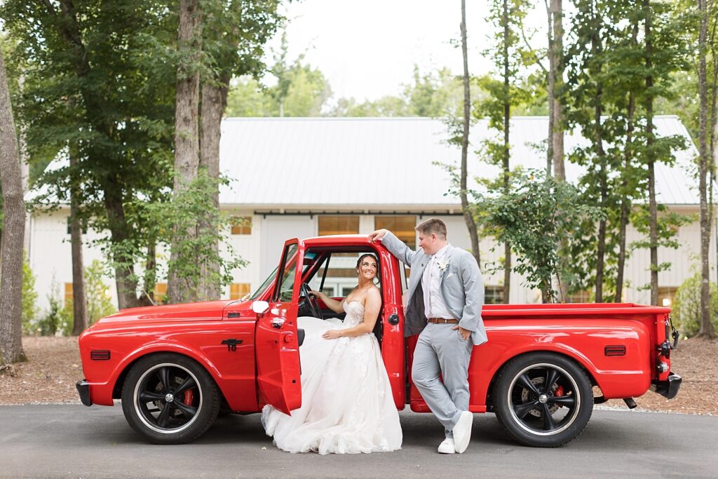 Bride sitting in red vintage truck | Blue and white Wedding | Carolina Groves Wedding | Carolina Groves Wedding Photographer | Raleigh NC Wedding Photographer