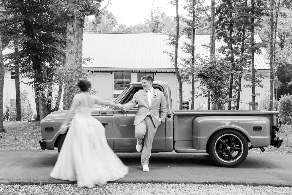 Bride and groom holding hands by vintage truck | Blue and white Wedding | Carolina Groves Wedding | Carolina Groves Wedding Photographer | Raleigh NC Wedding Photographer