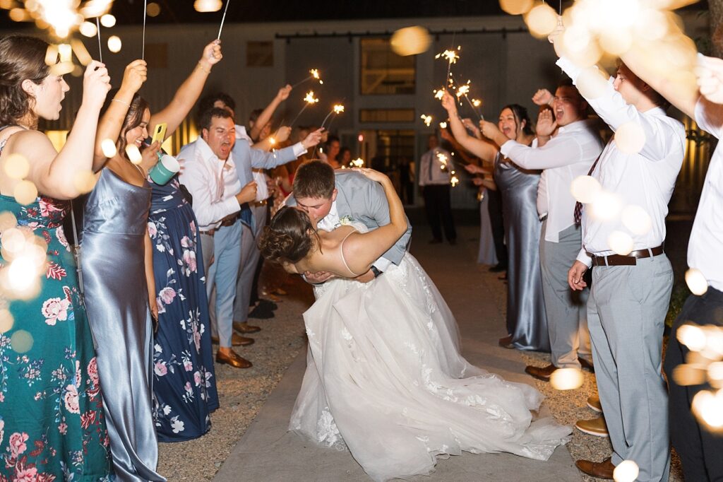 Bride and groom kissing during sparkler exit | Blue and white Wedding | Carolina Groves Wedding | Carolina Groves Wedding Photographer | Raleigh NC Wedding Photographer