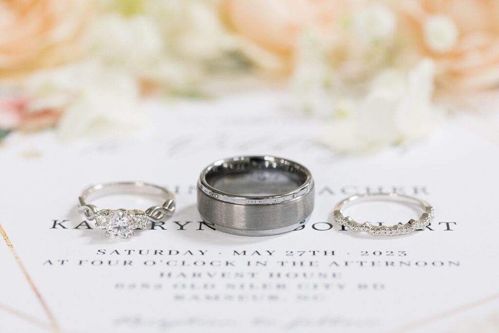 Wedding rings displayed on top of wedding invitations | Rustic wedding | Harvest House Wedding | Harvest House Photographer | Raleigh NC Wedding Photographer